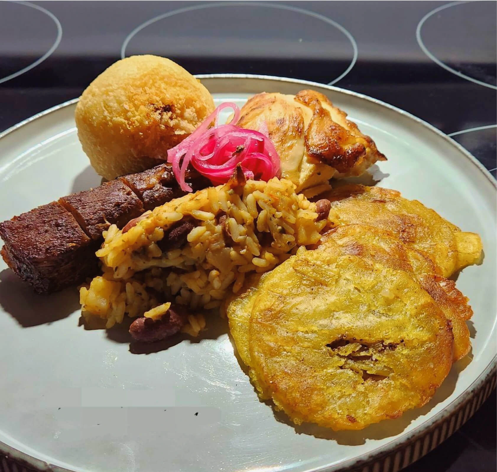 A plate showcasing a delectable combination of rice, beans, and meat, forming a tantalizing meal